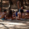 Gruppo di bambini seduti in cerchio nel bosco.